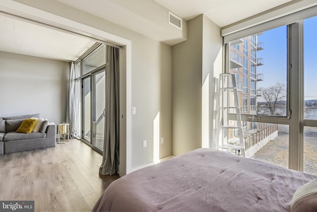 bedroom featuring hardwood / wood-style floors and multiple windows