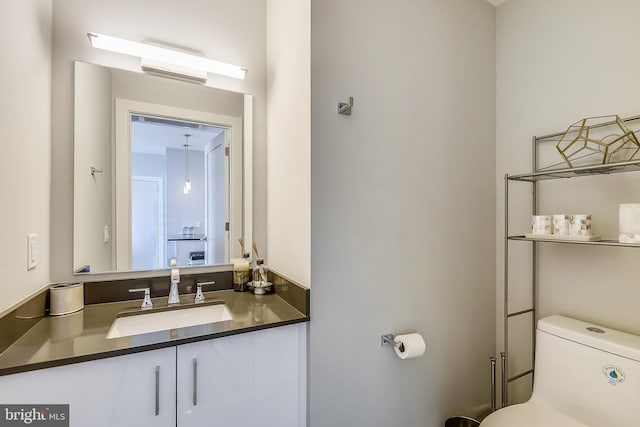 bathroom featuring vanity and toilet