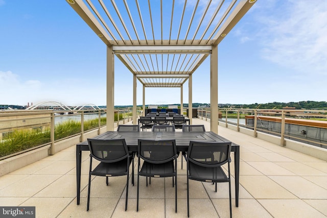 view of patio / terrace with a water view and a pergola