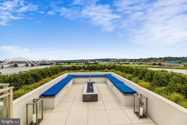 view of pool featuring a water view and a patio