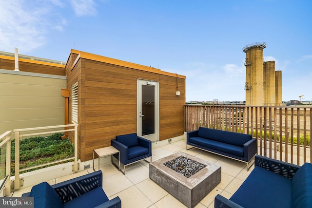 view of patio featuring an outdoor living space with a fire pit and a shed