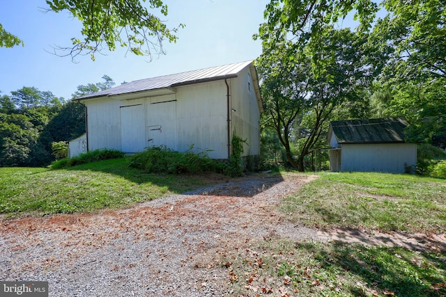 view of outbuilding with a yard