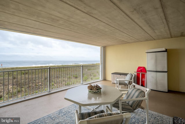 interior space featuring a water view and a beach view