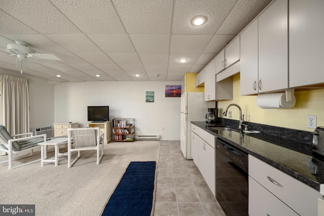 kitchen with white cabinetry, baseboard heating, sink, ceiling fan, and black dishwasher