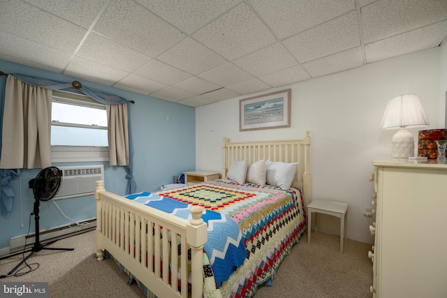 bedroom with a drop ceiling, carpet, and baseboard heating