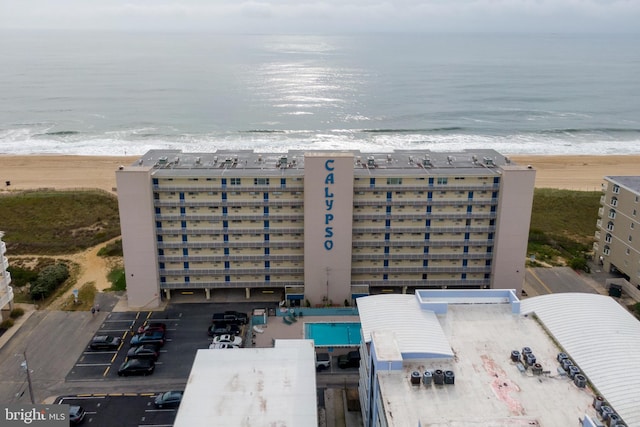 birds eye view of property with a beach view and a water view