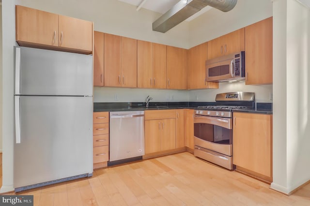 kitchen featuring sink, light brown cabinets, appliances with stainless steel finishes, and light hardwood / wood-style floors