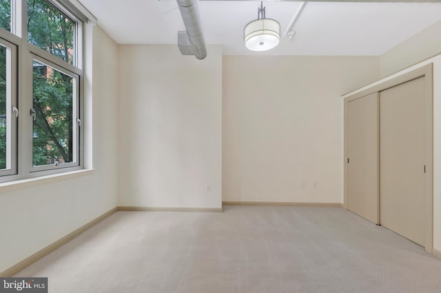 unfurnished bedroom featuring light colored carpet