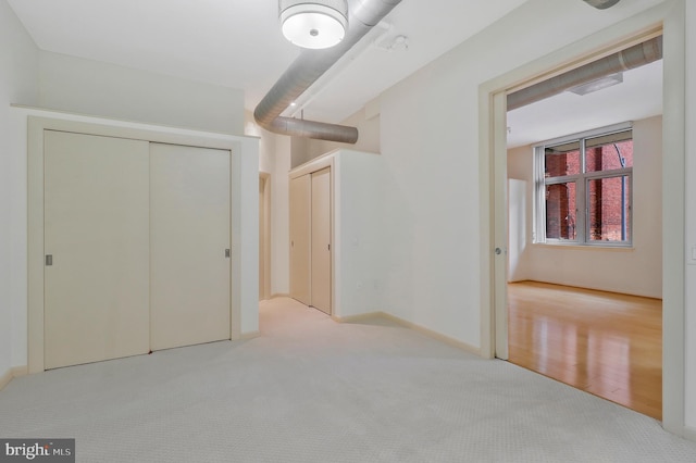 unfurnished bedroom with light wood-type flooring