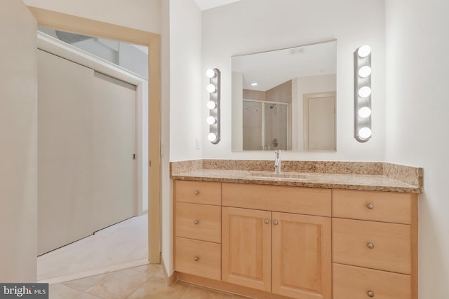 bathroom featuring vanity, tile patterned floors, and walk in shower