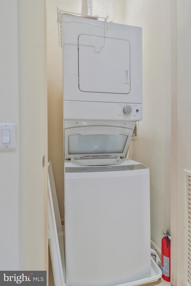 laundry room featuring stacked washer / dryer