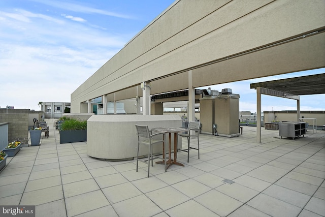 view of patio / terrace featuring a pergola and exterior bar