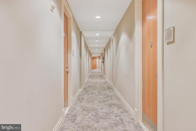 corridor featuring light colored carpet