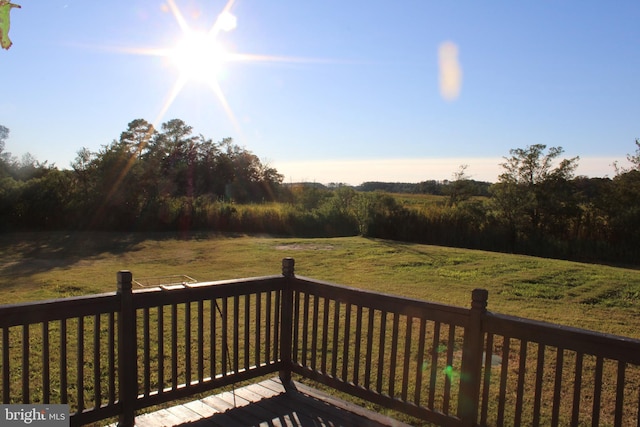 wooden terrace featuring a rural view