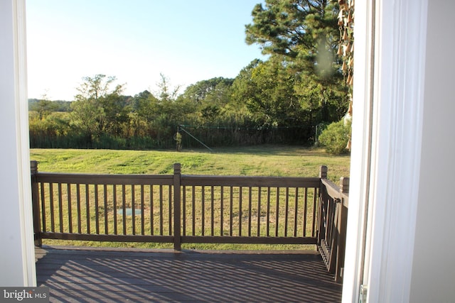 wooden deck featuring a yard