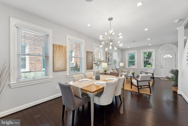 dining room with plenty of natural light, a notable chandelier, and dark hardwood / wood-style floors