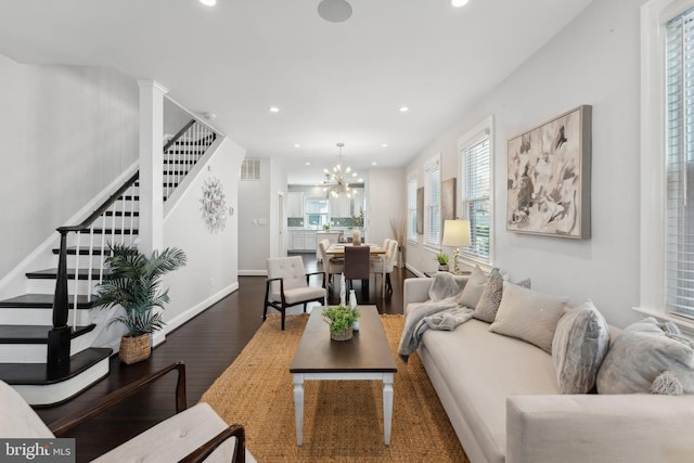 living room featuring visible vents, wood finished floors, recessed lighting, stairway, and a chandelier