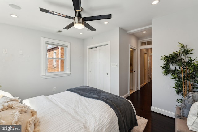 bedroom with dark wood-type flooring, a closet, and ceiling fan