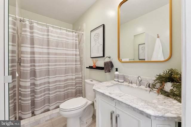 bathroom featuring vanity, toilet, and walk in shower