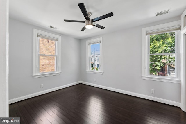 unfurnished room with plenty of natural light, ceiling fan, and dark hardwood / wood-style floors