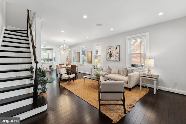 living area with baseboards, recessed lighting, stairs, wood-type flooring, and a chandelier