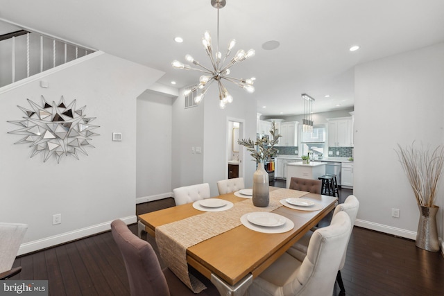 dining area with a notable chandelier and dark hardwood / wood-style floors