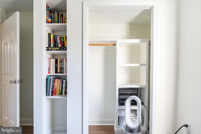 washroom featuring built in shelves and hardwood / wood-style flooring