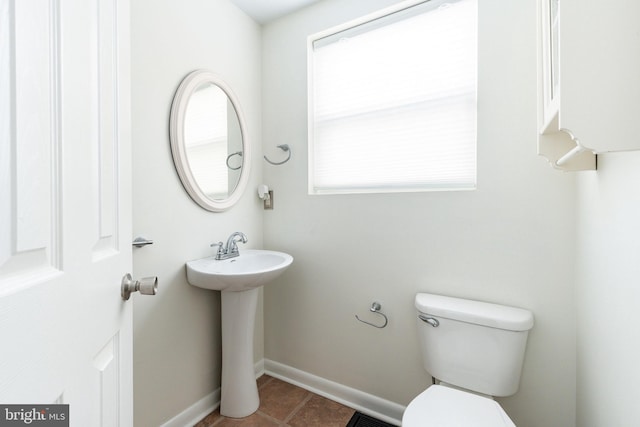 bathroom featuring toilet and tile patterned floors