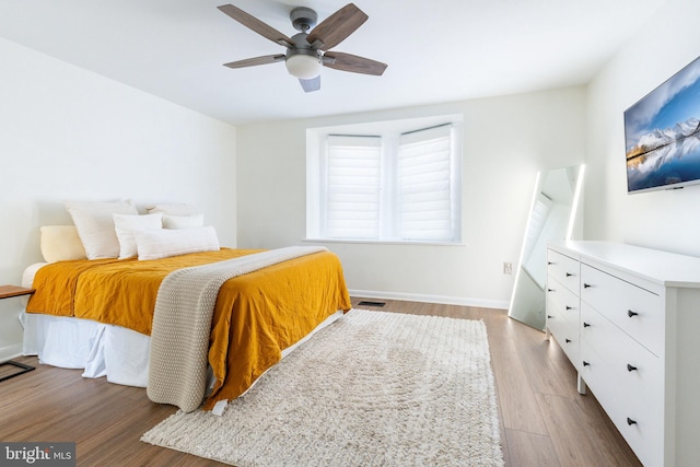 bedroom featuring light hardwood / wood-style floors and ceiling fan