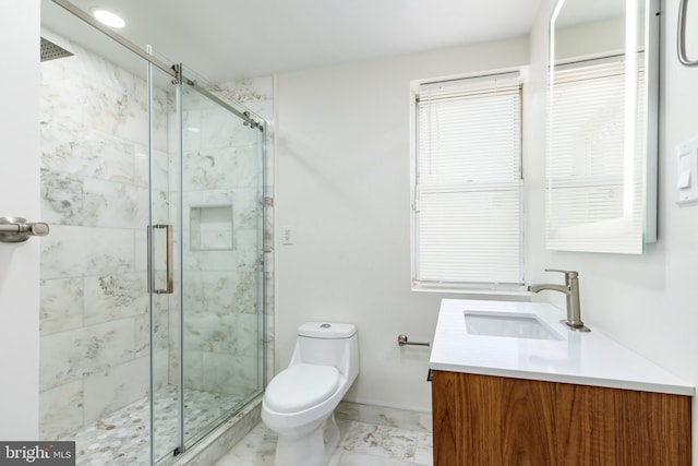 bathroom featuring vanity, toilet, and a shower with door