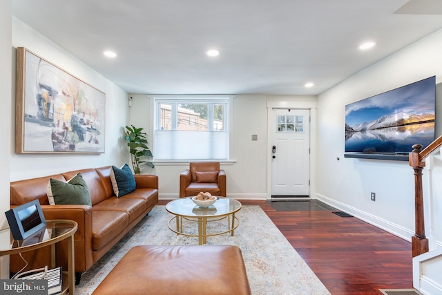 living room with dark hardwood / wood-style flooring