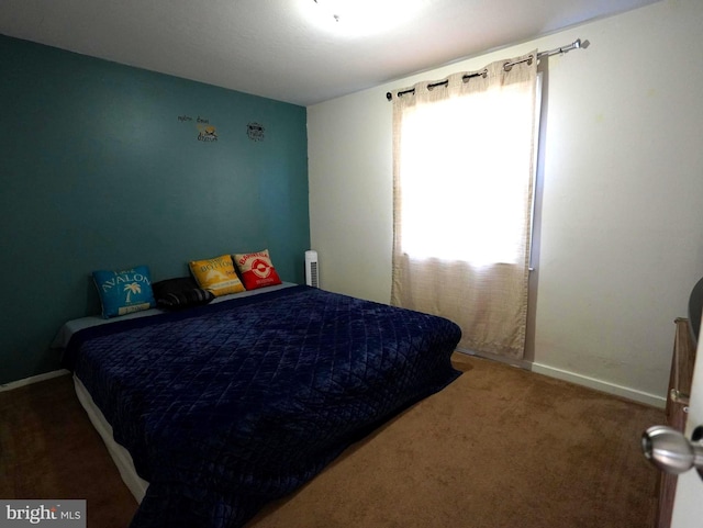 bedroom featuring carpet and baseboards