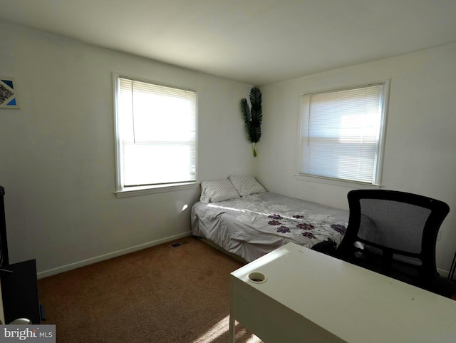 bedroom with carpet flooring and baseboards