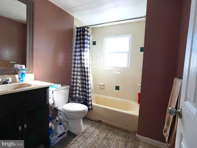 bathroom featuring shower / bathtub combination with curtain, toilet, and vanity