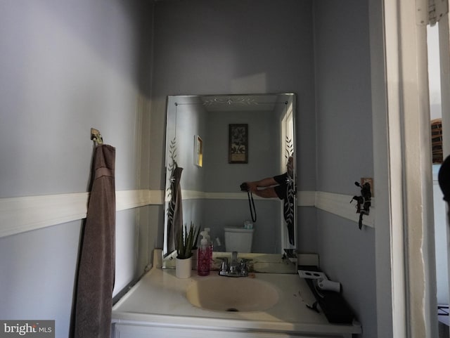 bathroom featuring toilet and vanity