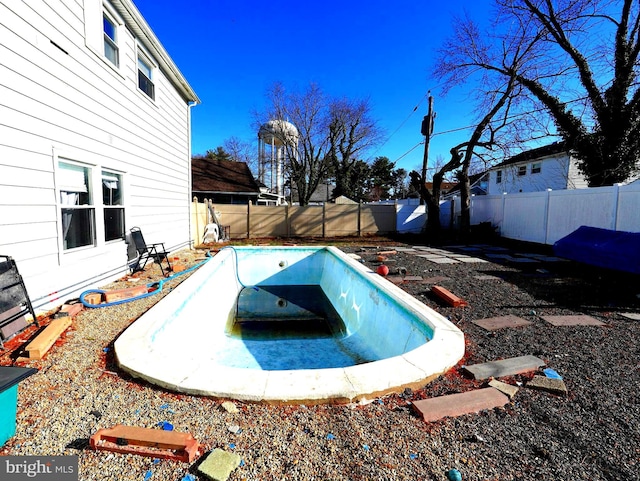 view of swimming pool with a fenced backyard