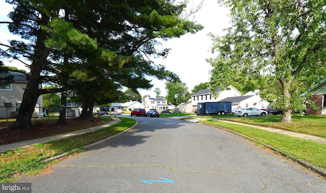 view of street with curbs, sidewalks, and a residential view