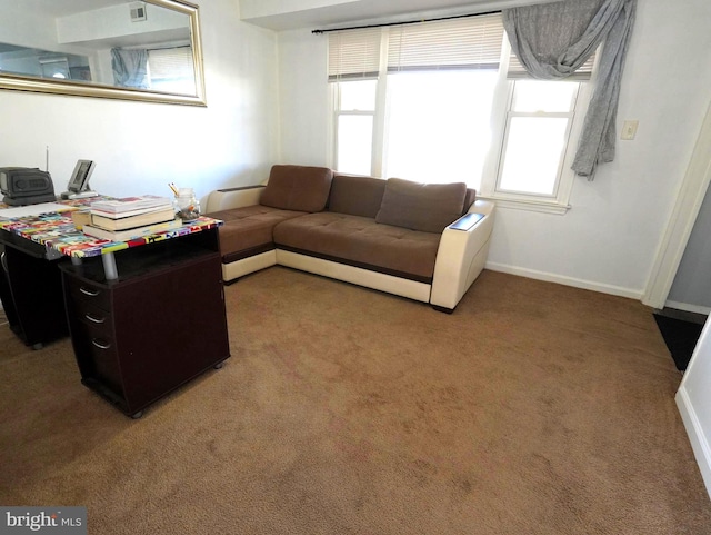 living room featuring light colored carpet and baseboards