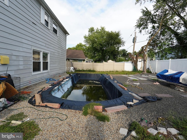 view of yard with a covered pool