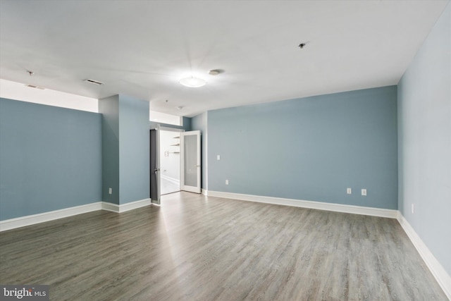 unfurnished room with wood-type flooring