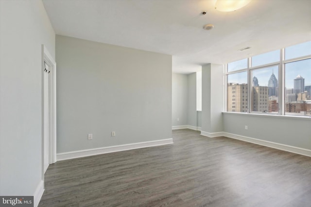 empty room featuring dark hardwood / wood-style flooring