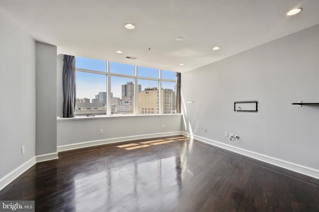 unfurnished room with wood-type flooring