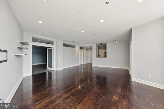 spare room with dark wood-type flooring