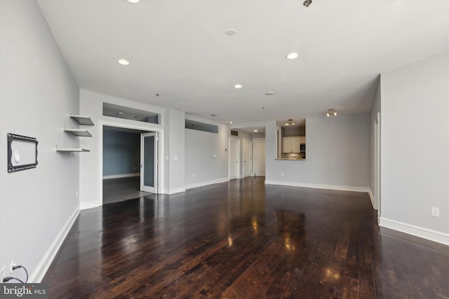 spare room featuring dark hardwood / wood-style flooring