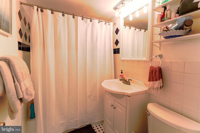 bathroom with vanity, a shower with shower curtain, tile patterned flooring, tile walls, and toilet