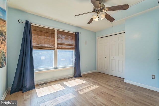 unfurnished bedroom with visible vents, baseboards, light wood-type flooring, and a closet