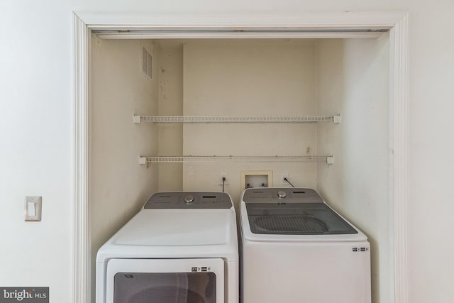 clothes washing area with laundry area, independent washer and dryer, and visible vents