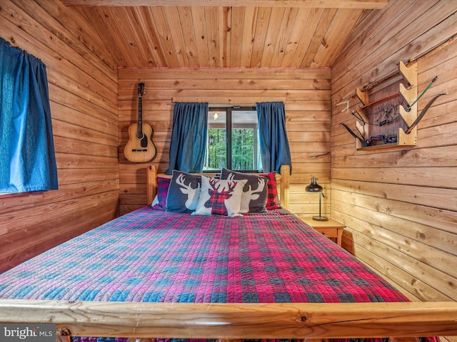 bedroom with wooden walls and wooden ceiling