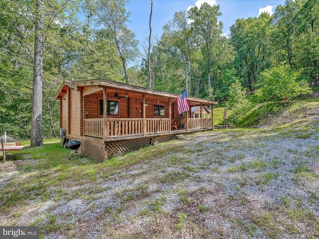 back of house featuring a deck and a yard