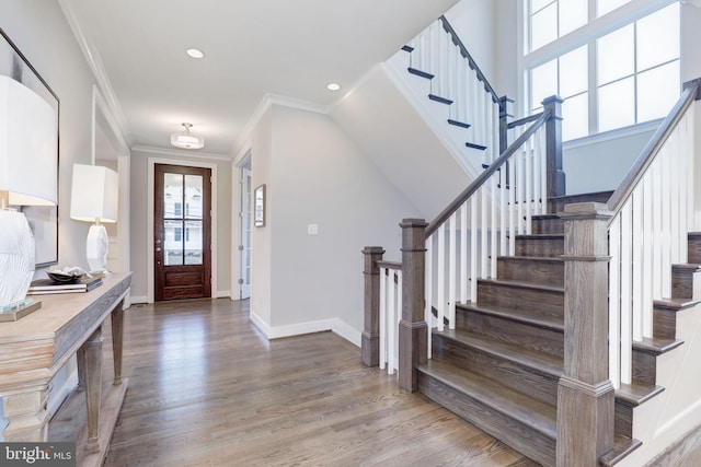 foyer entrance featuring crown molding and hardwood / wood-style flooring